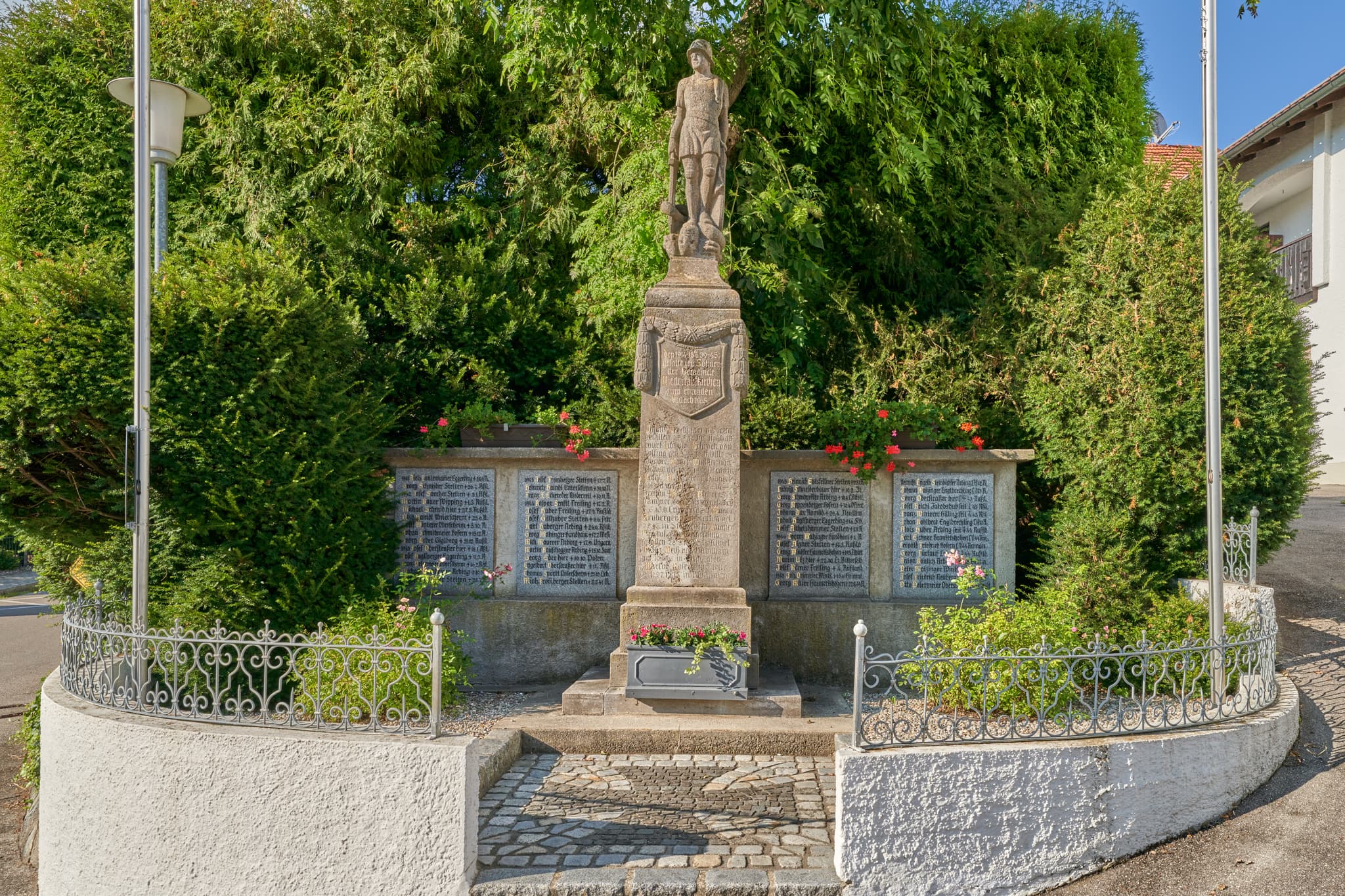 Kriegerdenkmal Niedertaufkirchen, Mühldorf, Oberbayern - Das Kriegerdenkmal in Niedertaufkirchen, Mühldorf am Inn, Oberbayern, ist ein detailreiches Monument. Umgeben von Grün und Zaun, dient es als Gedenkort.