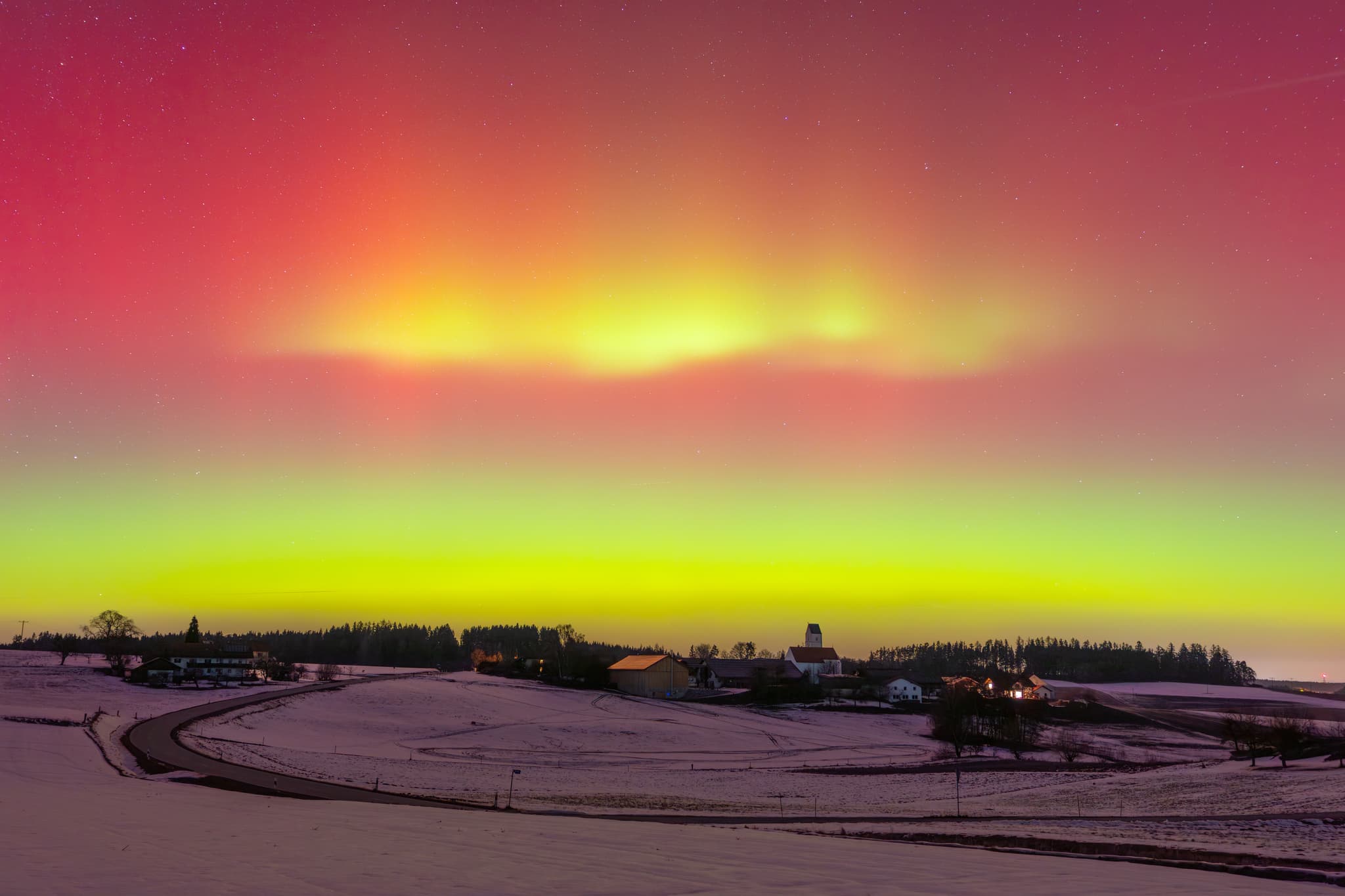Landschaft mit Polarichter über Ecking, Reischach, Altötting - Ecking, Reischach, Landkreis Altötting, Oberbayern. Farbenprächtiges Polarlicht erhellt Winterhimmel über verschneiter Holzland Landschaft - Naturereignis.
