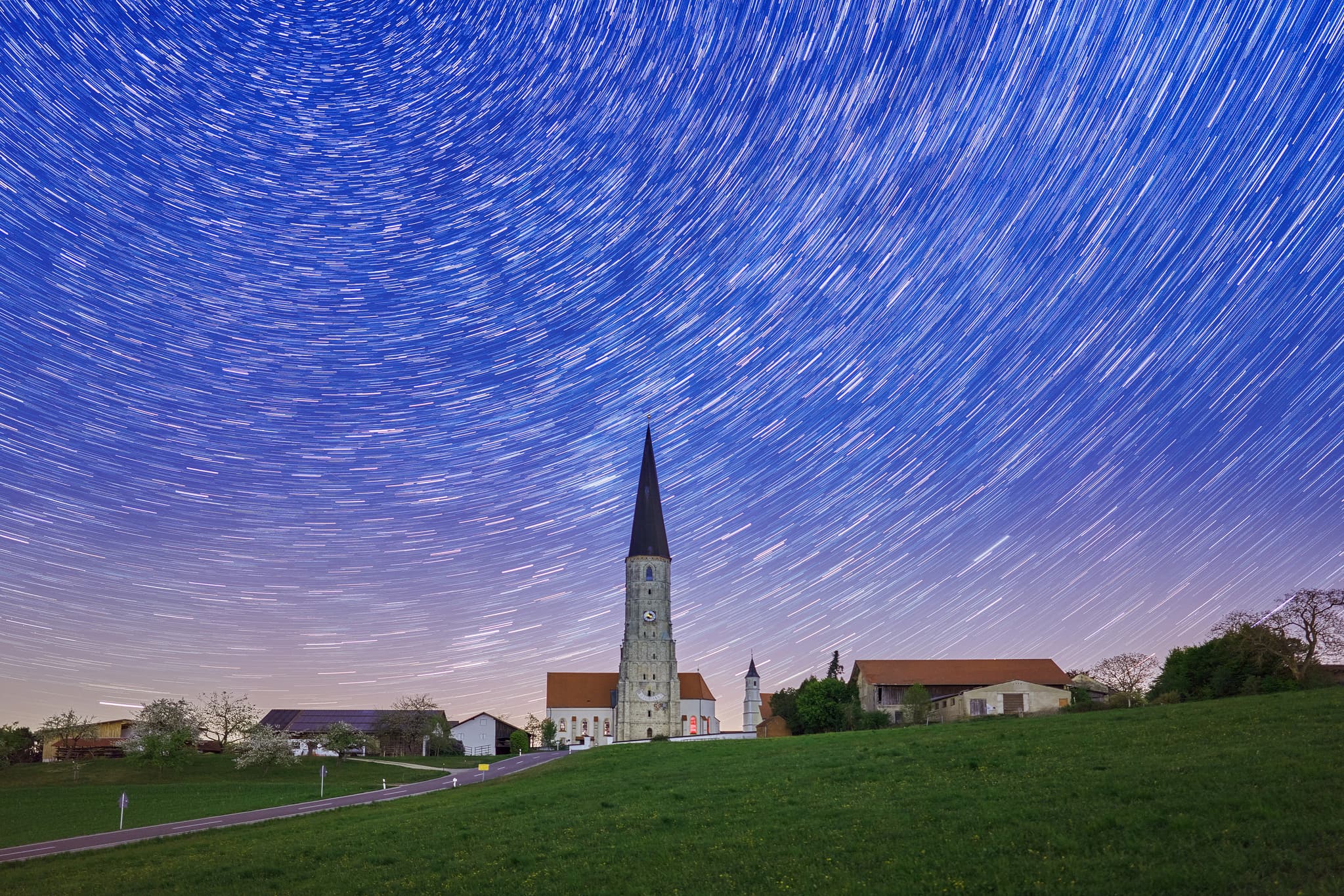 Schildthurn bei Nacht mit Startrails, Niederbayern - Kirchenturm Schildthurn, Zeilarn, Rottal-Inn, Niederbayern, Deutschland. Nachtaufnahme. Gute Bedingungen für Nachtfotografie