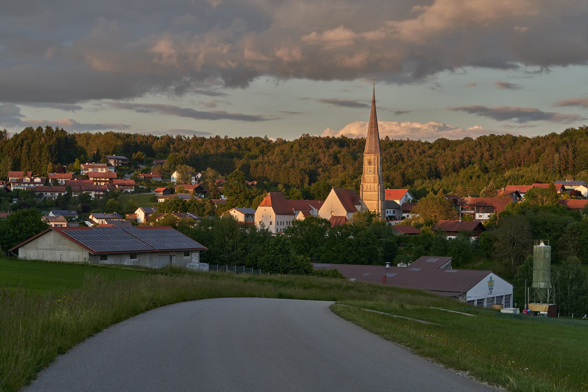 Taubenbach Ortsansicht, Bürgermeister-Alfranseder-Straße - Entdecken Sie den Charme von Taubenbach im Landkreis Rottal-Inn, Niederbayern. Ein malerisches Dorf mit einem markanten Kirchturm, der den Ort von weitem prägt.
