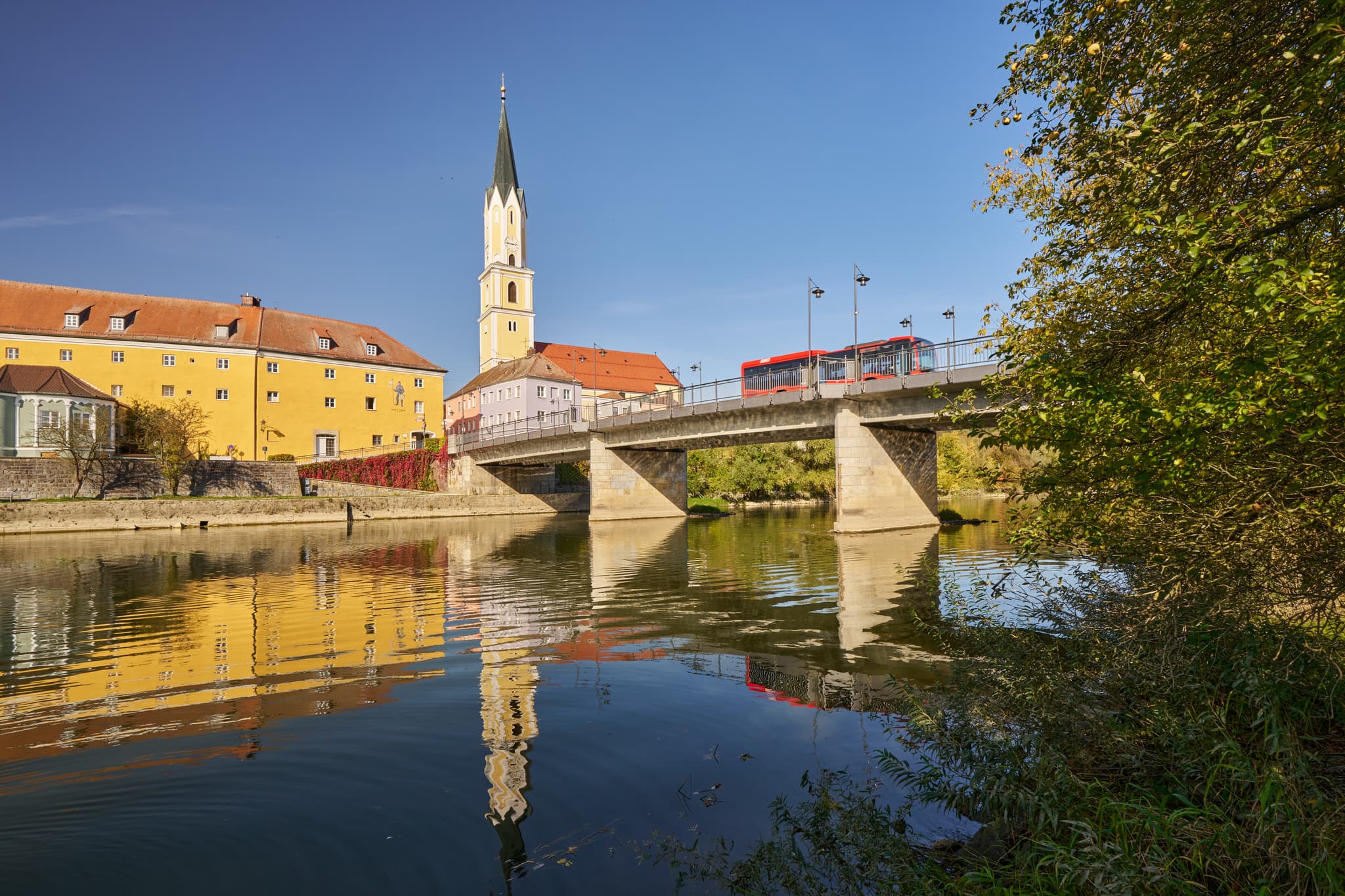 Vils Stadtansicht, Vilshofen, Passau, Niederbayern - Stadtansicht Vilshofen an der Vils, Landkreis Passau, Niederbayern. Historische Gebäude, Kirchturm und Brücke spiegeln sich im Fluss. Donau-Wald, Deutschland.